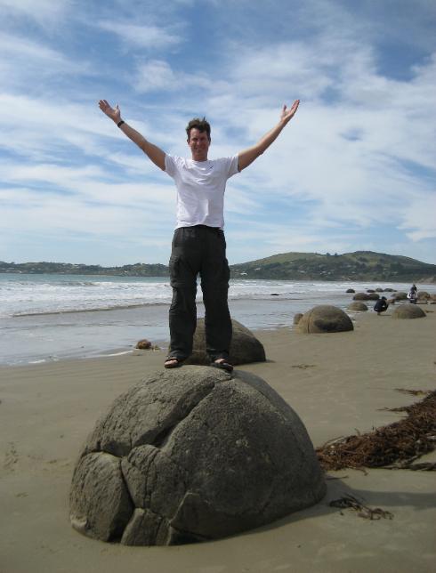 Standing on one of the Boulders of Moeraki near Oamaru