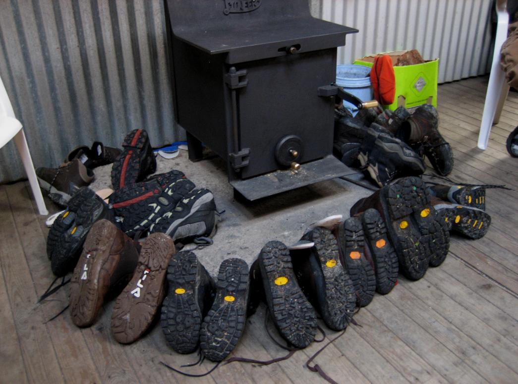 Wet boots gathered around the stove (Day 3)