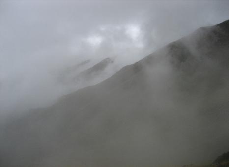 Mood shot of misty mountains with a faint tinge of sunlight